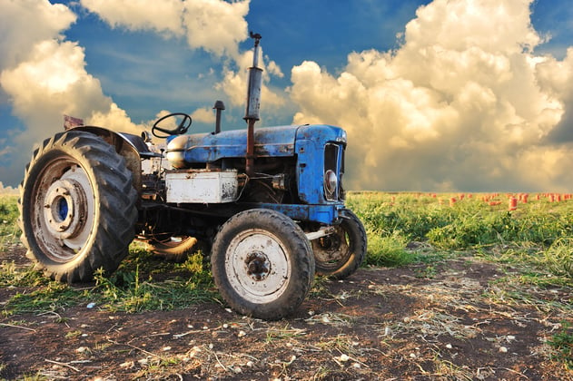 Very old tractor in field, different parts - no trademark at all